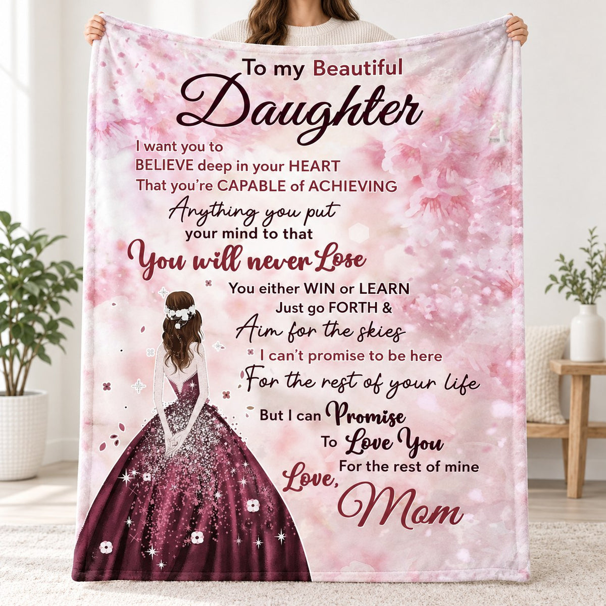 To My Beautiful Daughter blanket from Mom with Win or Learn message, pink blossoms and girl in ball gown, held up in a bright room